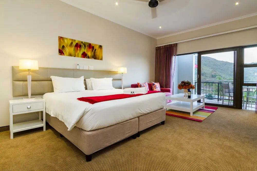 Spacious bedroom at Piekenierskloof Mountain Lodge in the Cederberg, Western Cape, South Africa, with mountain views and private balcony