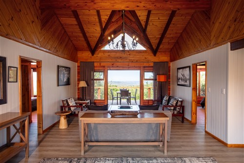 Spacious lounge at Kariega Game Reserve Main Lodge overlooking the Eastern Cape bush, featured by Wild Vine Travel for luxury malaria-free safari holidays in South Africa.